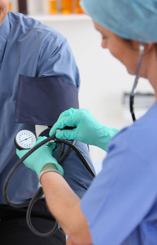 Blood pressure being monitored by doctor