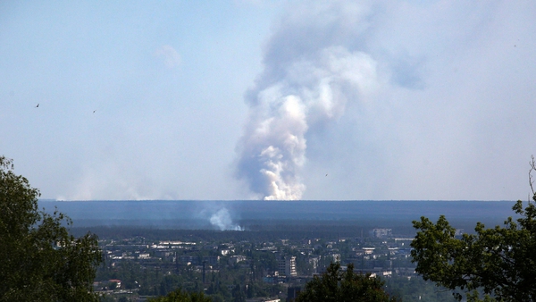 A large plume of smoke rising from behind the town of Sievierodonetsk