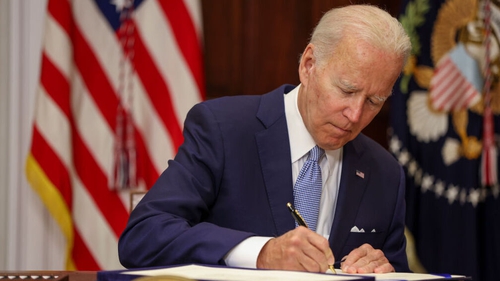 Joe Biden signs the Bipartisan Safer Communities Act into law in the Roosevelt Room of the White House