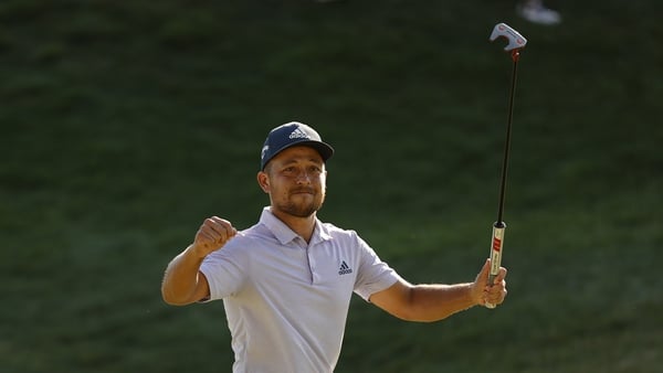Xander Schauffele celebrates after his putt on the 18th