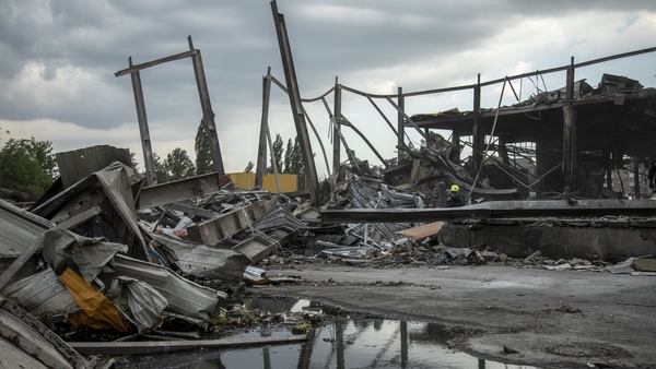 A fireman sits among the rubble of a shopping mall targeted by a missile strike in Kremenchuk, Ukraine