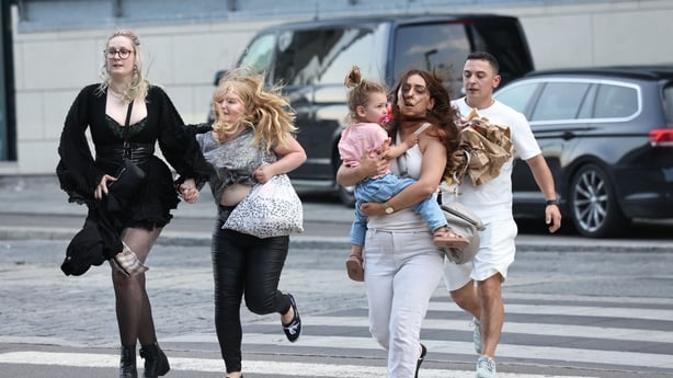 People run from the shopping centre