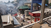 People look over the wreckage after a missile stuck a shopping mall in Sloviansk, Ukraine