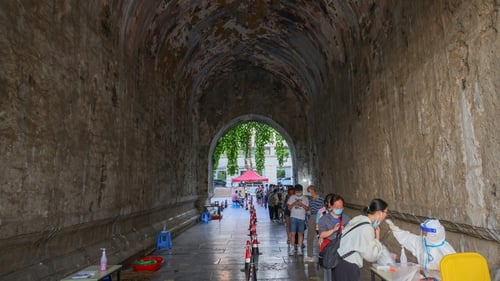 People queue for Covid-19 tests at Nanjing City Wall in Jiangsu Province