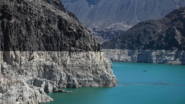 A 'bathtub ring', a white band of mineral deposits showing previous water levels, is visible at Lake Mead