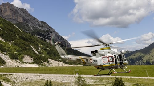 A rescue helicopter takes off near the Marmolada glacier in the Italian Dolomites today