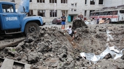 A large crater is left after a Russian missile attack on a school in the Saltivskyi district of Kharkiv