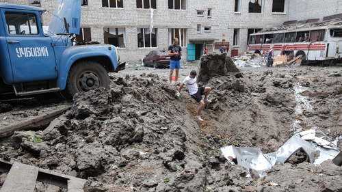 A large crater is left after a Russian missile attack on a school in the Saltivskyi district of Kharkiv