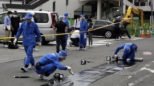 Police examine the scene after the shooting of Shinzo Abe