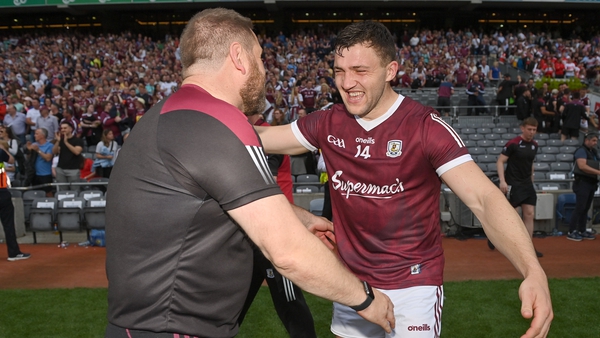 Comer celebrates with Galway coach Cian O'Neil afterwards