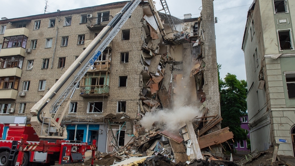 Rescuers dismantle slabs of a destroyed building in the centre of Kharkiv