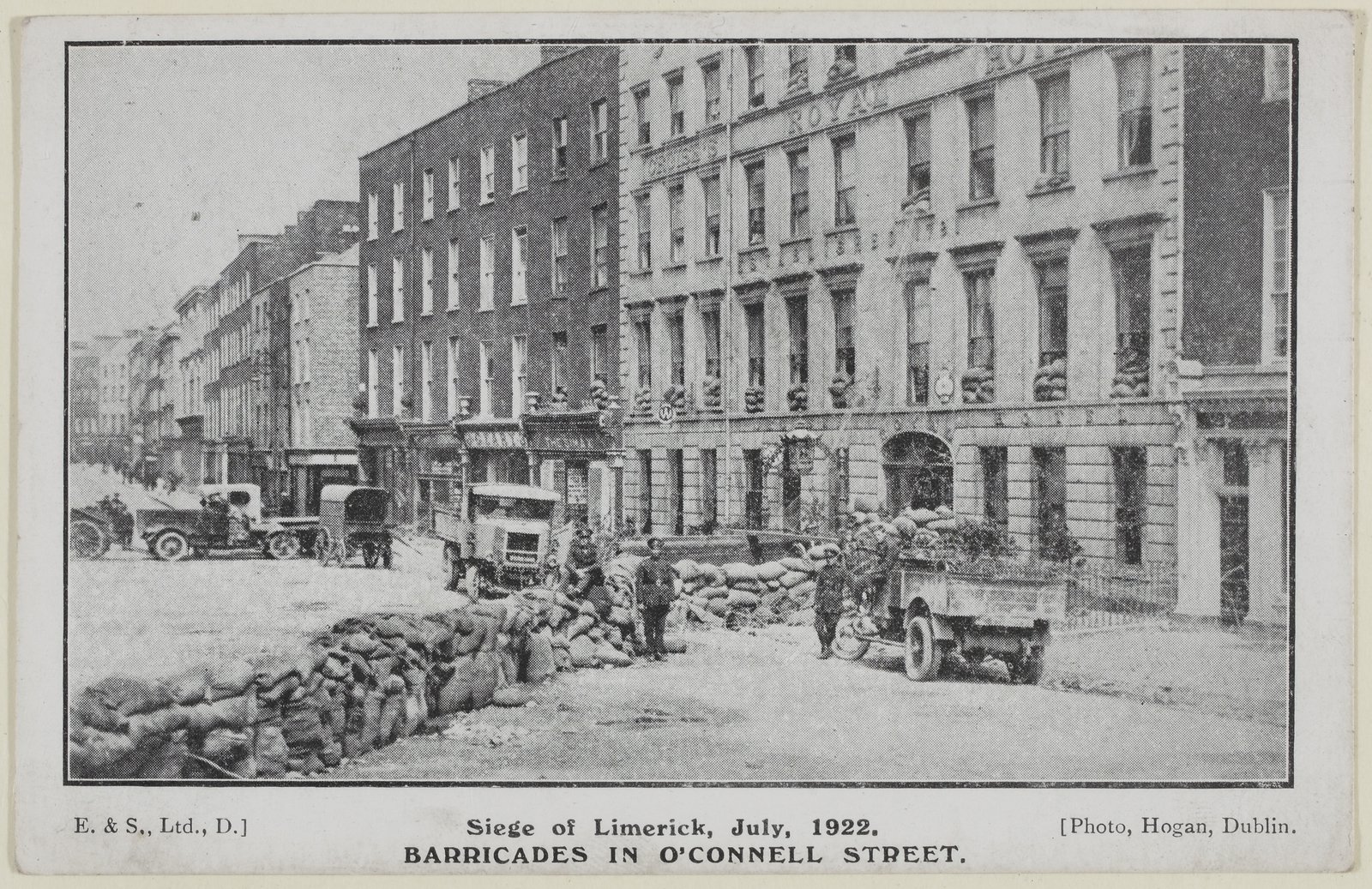 Image - Postcard featuring a photograph taken by D. Hogan, depicting O'Connell Street, Limerick with barricades. Image courtesy of the National Library of Ireland