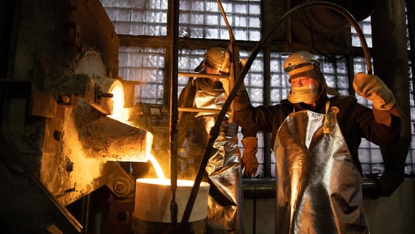 Workers fill a crucible with molten gold in the foundry at the Prioksky non-ferrous metals plant in Kasimov