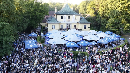 Guests enjoy the Kocherlball at the Chinese Tower in the English Garden in Munich at the weekend
