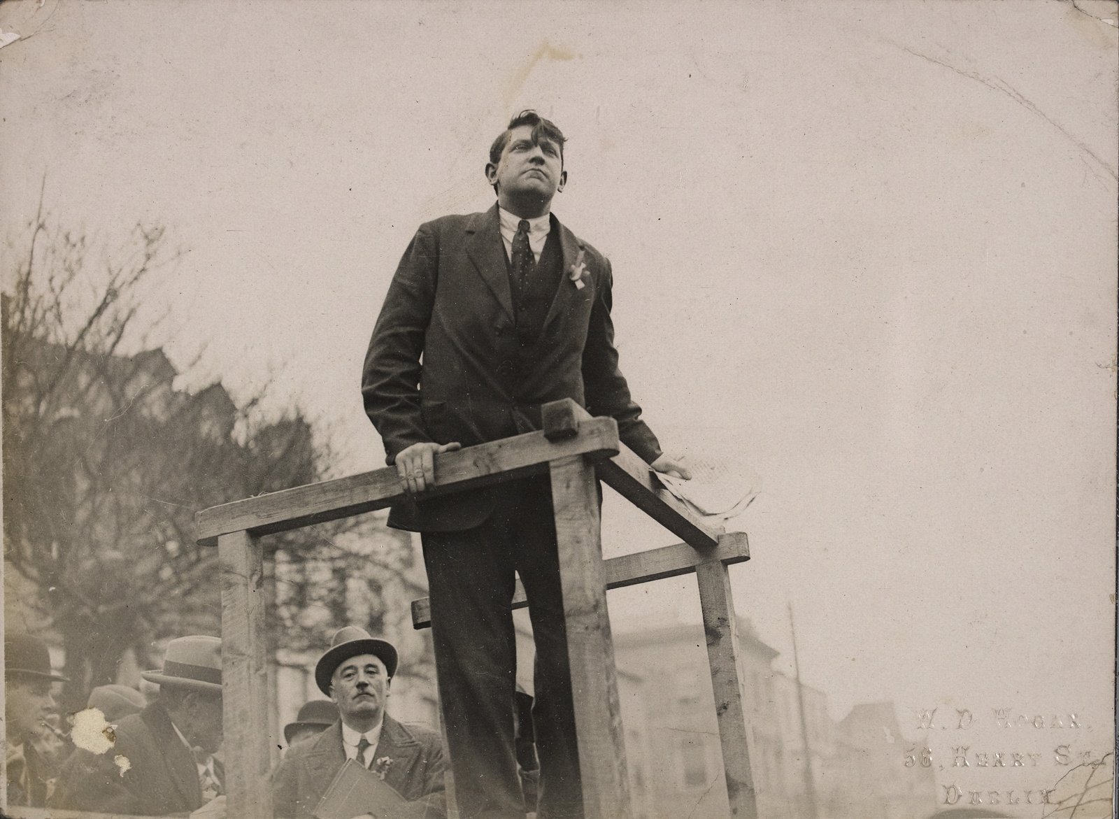 Image - "The Defiant Chief": Michael Collins speaking from podium. Image courtesy of the National Library of Ireland