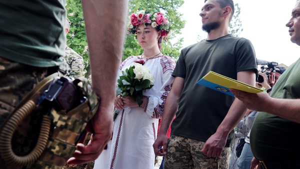 Soldiers Vitalii Orlich and his bride Kristina get married during a joint wedding ceremony with two other soldiers in Druzhkivka, Donetsk Oblast, Ukraine
