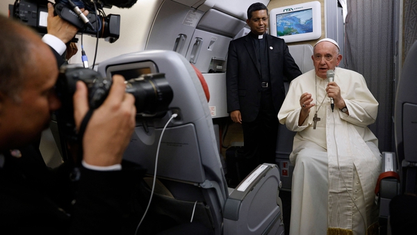Pope Francis sat in a wheelchair as he spoke to reporters on the flight back from Canada