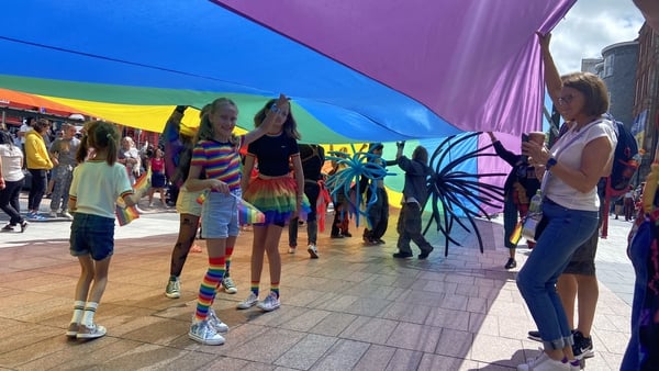 People take part in the 2022 Cork pride parade, which attracted thousands of people today
