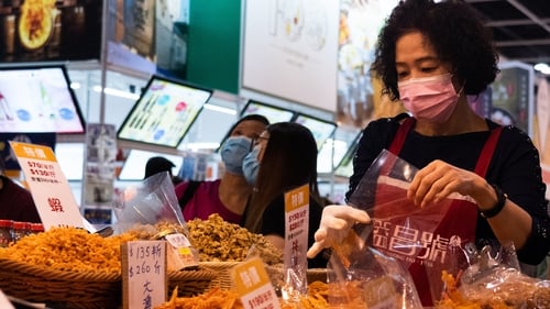 A vendor packs dry seafood at last year's Hong Kong food expo
