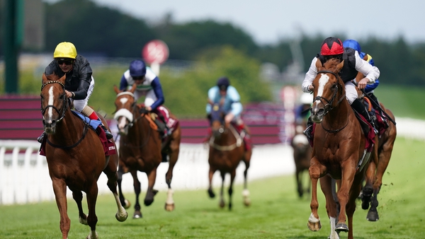 Kyprios ridden by Ryan Moore (right,) passes Stradivarius and Andrea Atzeni (left) on their way to winning the Goodwood Cup