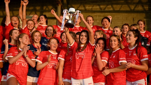 Cork captain Evie Twomey lifts the trophy, which the Rebels also won when the competition was last played in 2019