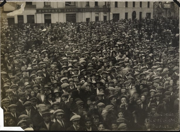 Sepia photo of a cheering crowd