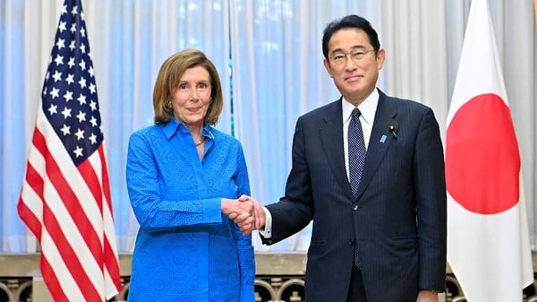 US House Speaker Nancy Pelosi shakes hands with Japanese Prime Minister Fumio Kishida during her visit to Japan