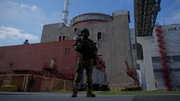 A Russian serviceman stands guard the territory outside the second reactor of the Zaporizhzhia Nuclear Power Station
