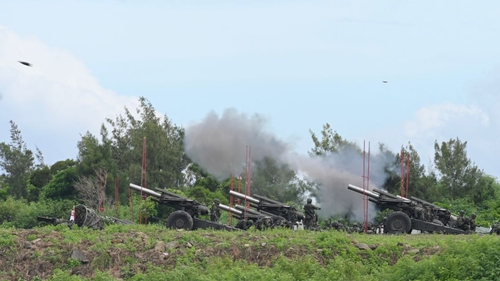 Taiwan military soldiers fire the 155-inch howitzers during a live fire anti landing drill in the Pingtung county, southern Taiwan