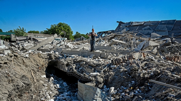 An official examines the ruins of a furniture factory following a missile strike on the second largest Ukrainian city of Kharkiv