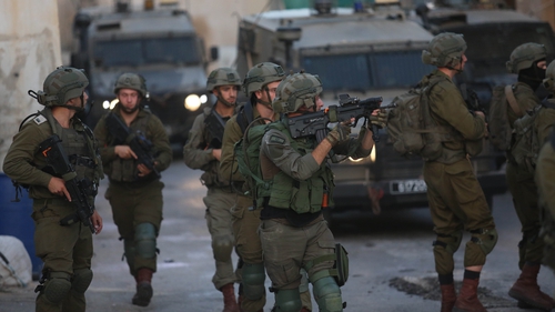 Israeli troops take security measures after the military destroyed two homes belonging to Palestinian detainees