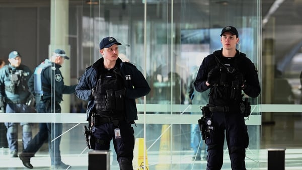 Police on patrol inside the airport terminal after the shooting