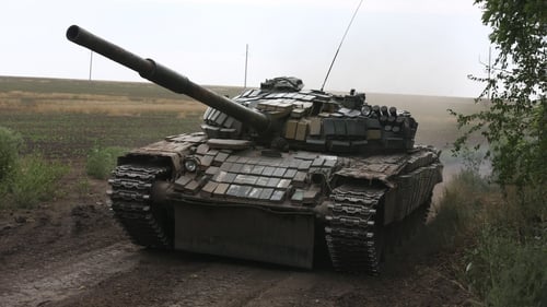 DPR servicemen in a tank to target enemy positions located near the city of Krasnohorivka in the Donetsk region