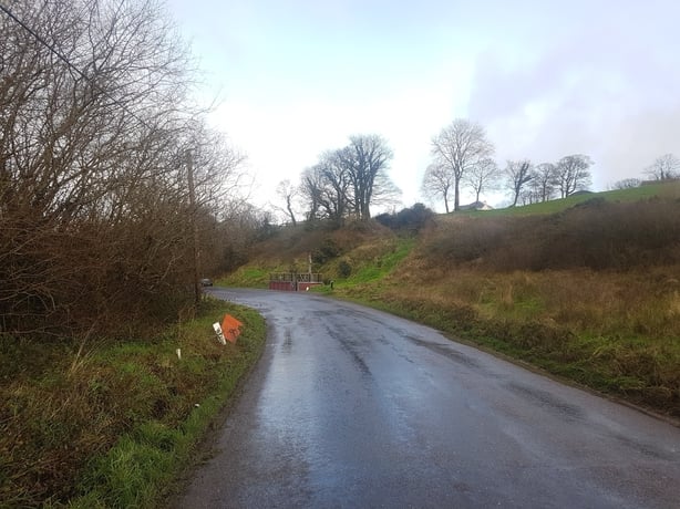 A country road lined with ditches and hedgerows