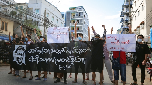Demonstrators hold a banner during a protest against the execution of four pro-democracy activists in July
