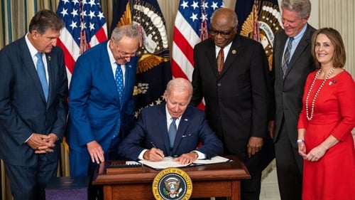 President Joe Biden signs the Inflation Reduction Act of 2022 into law in the White House