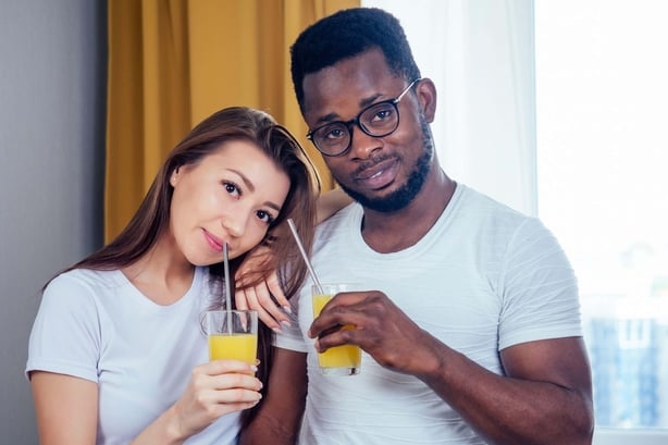 Couple drinking fruit drinks together
