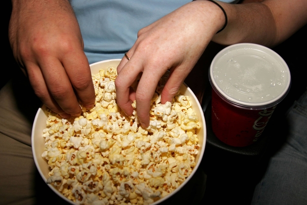 Couple eating popcorn with hands