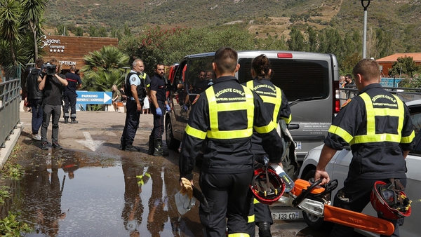 French Securite Civile rescuers enter the Sagone camping in Coggia, where a tree fell on a tent killing a young girl
