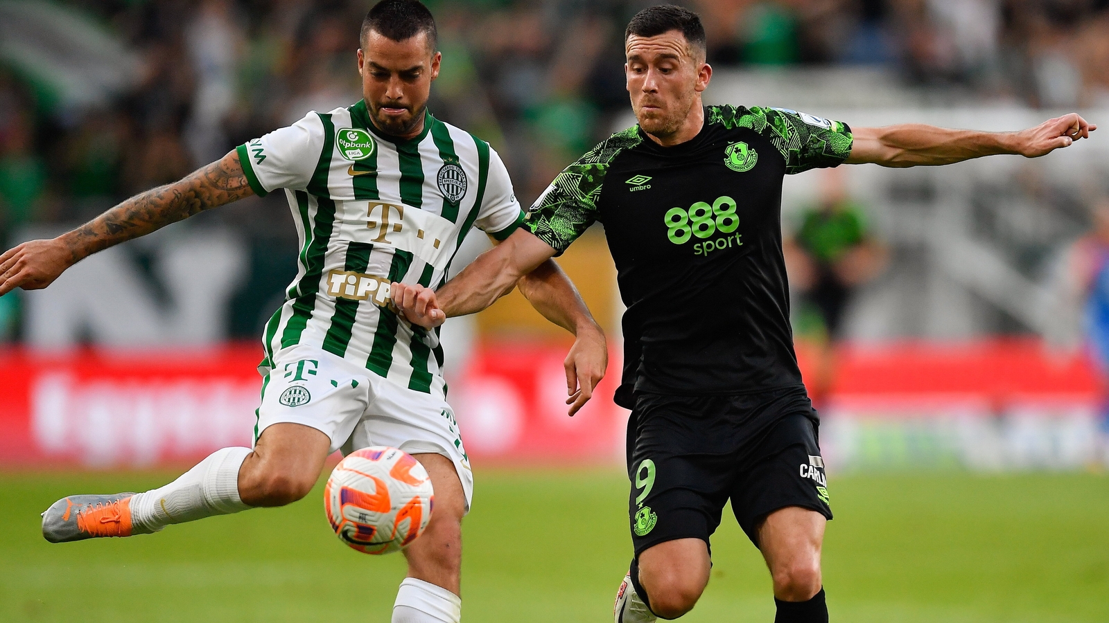 Mats Knoester of Ferencvarosi TC competes for the ball with