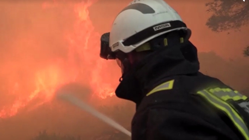 A firefighter battling a blaze in Valencia, Spain