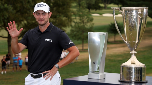 Patrick Cantlay of the United States poses with the trophy after putting in to win on the 18th green during the final round of the BMW Championship at Wilmington Country Club on August 21, 2022 in Wilmington, Delaware.