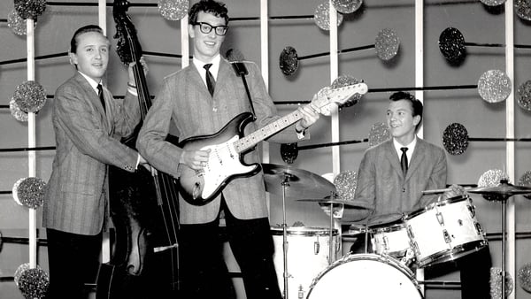 Buddy Holly and the Crickets (L-R Joe B Mauldin, Buddy Holly, and Jerry Allison) pose for a group shot on the set of the BBC television show Off the Record during their UK tour in 1958 Photos: Getty Images