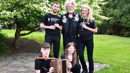 U2's Adam Clayton with Music Generation Waterford Laois members Conor Kenny and Sorcha Hennessy (standing); and Sean Lawler and Tove Byers (seated)