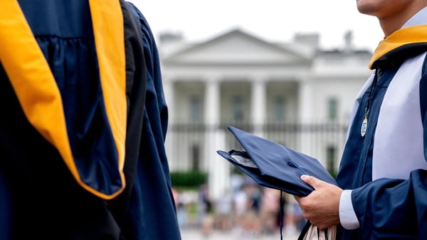 Students from George Washington University wear their graduation gowns outside of the White House in Washington, DC (File image)