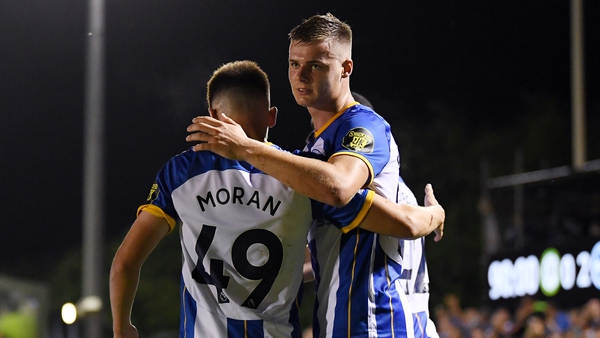 Evan Ferguson celebrates with team-mate Andy Moran after scoring Brighton's third goal