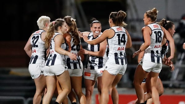 Aishling Sheridan (no 14) and the Collingwood players celebrate a goal against Carlton
