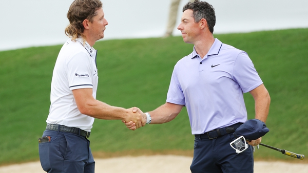 Cameron Smith and Rory McIlroy of Northern Ireland shake hands on the 18th green