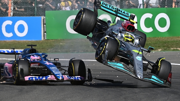 Lewis Hamilton (R) and Fernando Alonso collide in the opening lap
