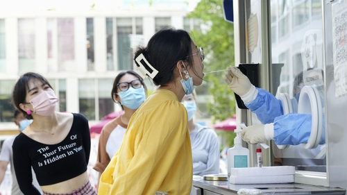 A woman is seen taking a Covid test in Beijing